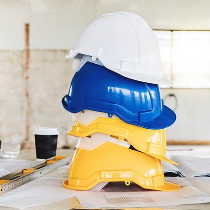 Safety helmet for engineering worker stacking on table in construction site.