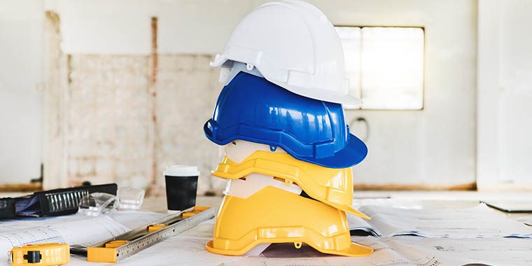 Safety helmet for engineering worker stacking on table in construction site.