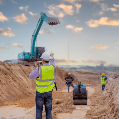 A surveyor engineer is at a construction site for a new road.