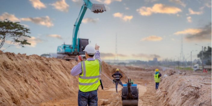 surveyor-enginer-at-a-road-construction-site.jpg A surveyor engineer is at a construction site for a new road.